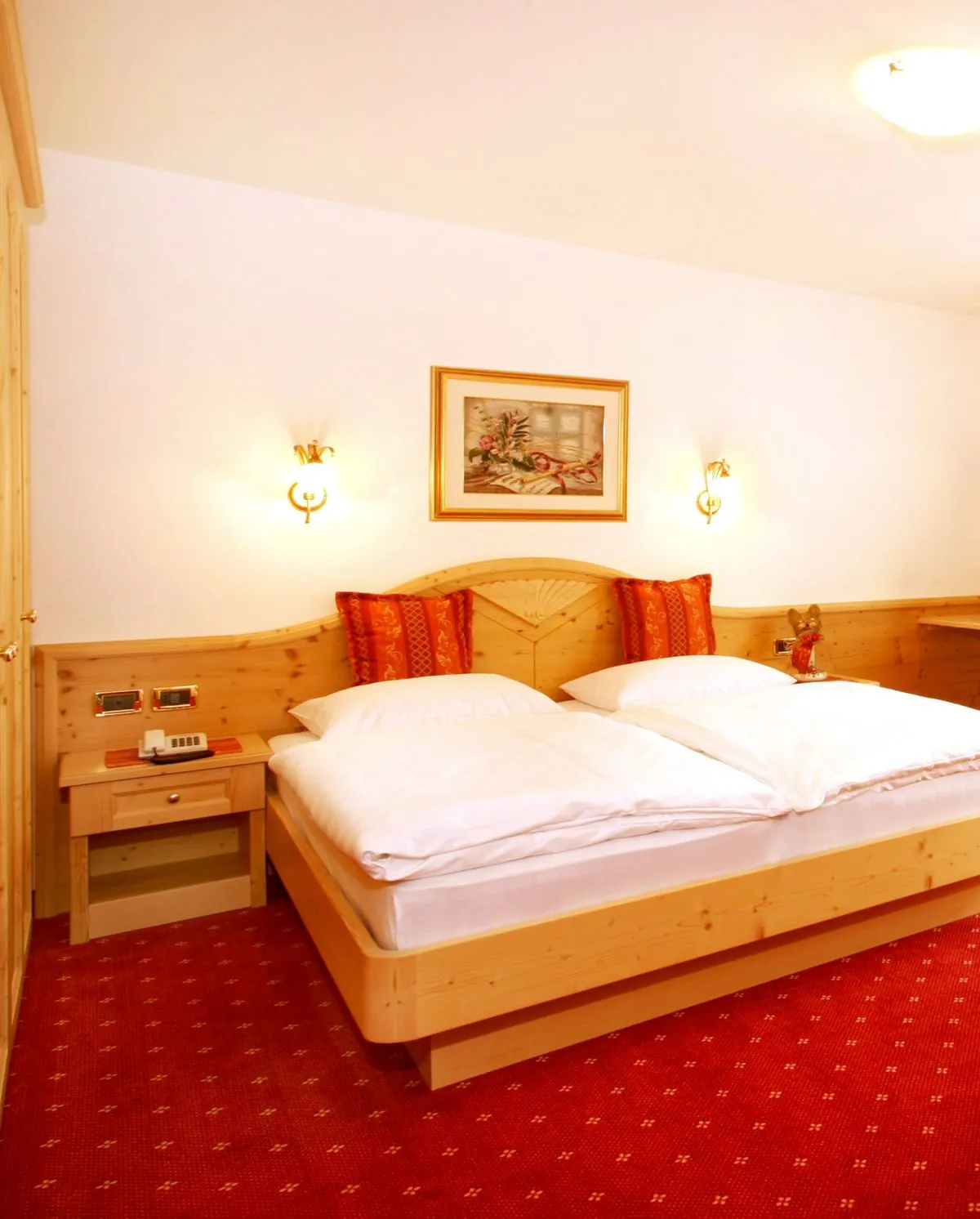 Schlafzimmer mit rotem Teppich und Holzbett